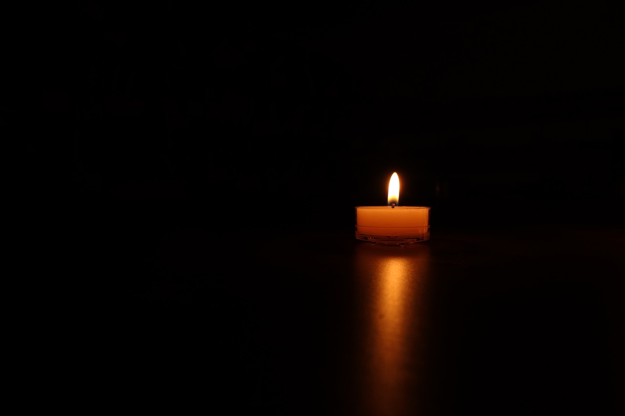 a lit candle in the dark on a table, a picture, minimalism, reflection, night photo, float, in the middle of the night