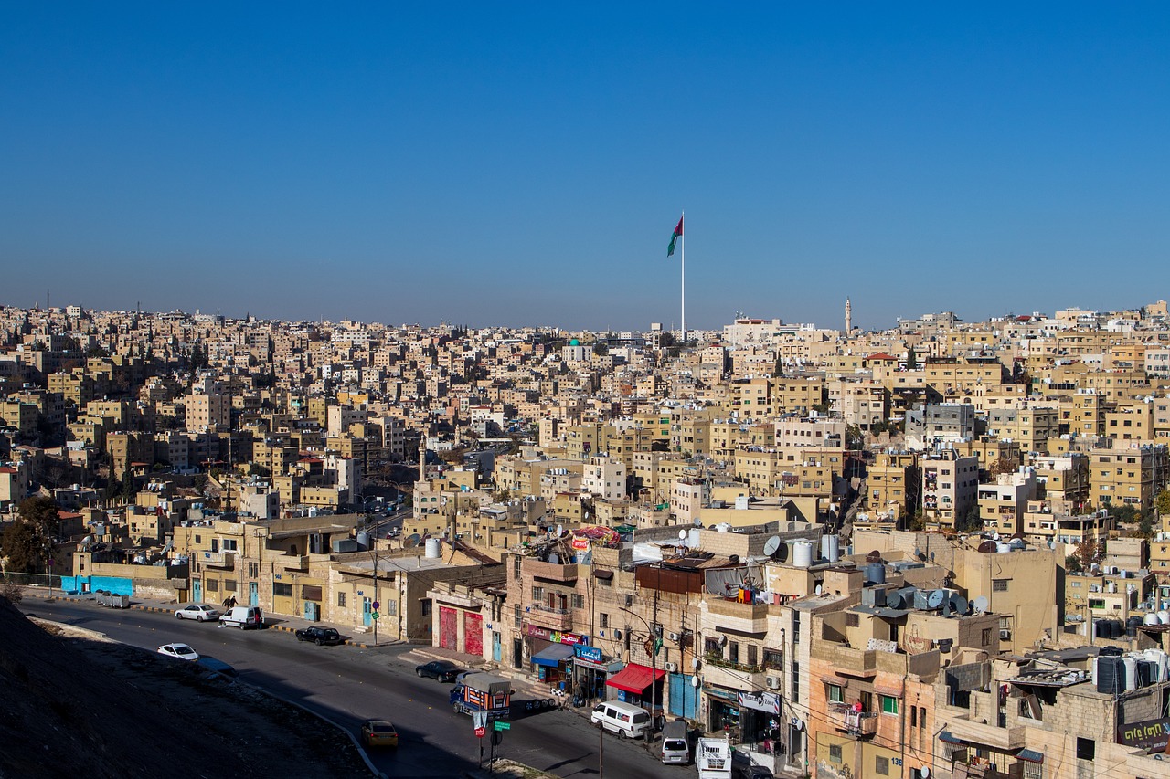 a city filled with lots of tall buildings, hurufiyya, jordan, in a city with a rich history, beautiful sunny day, blonde