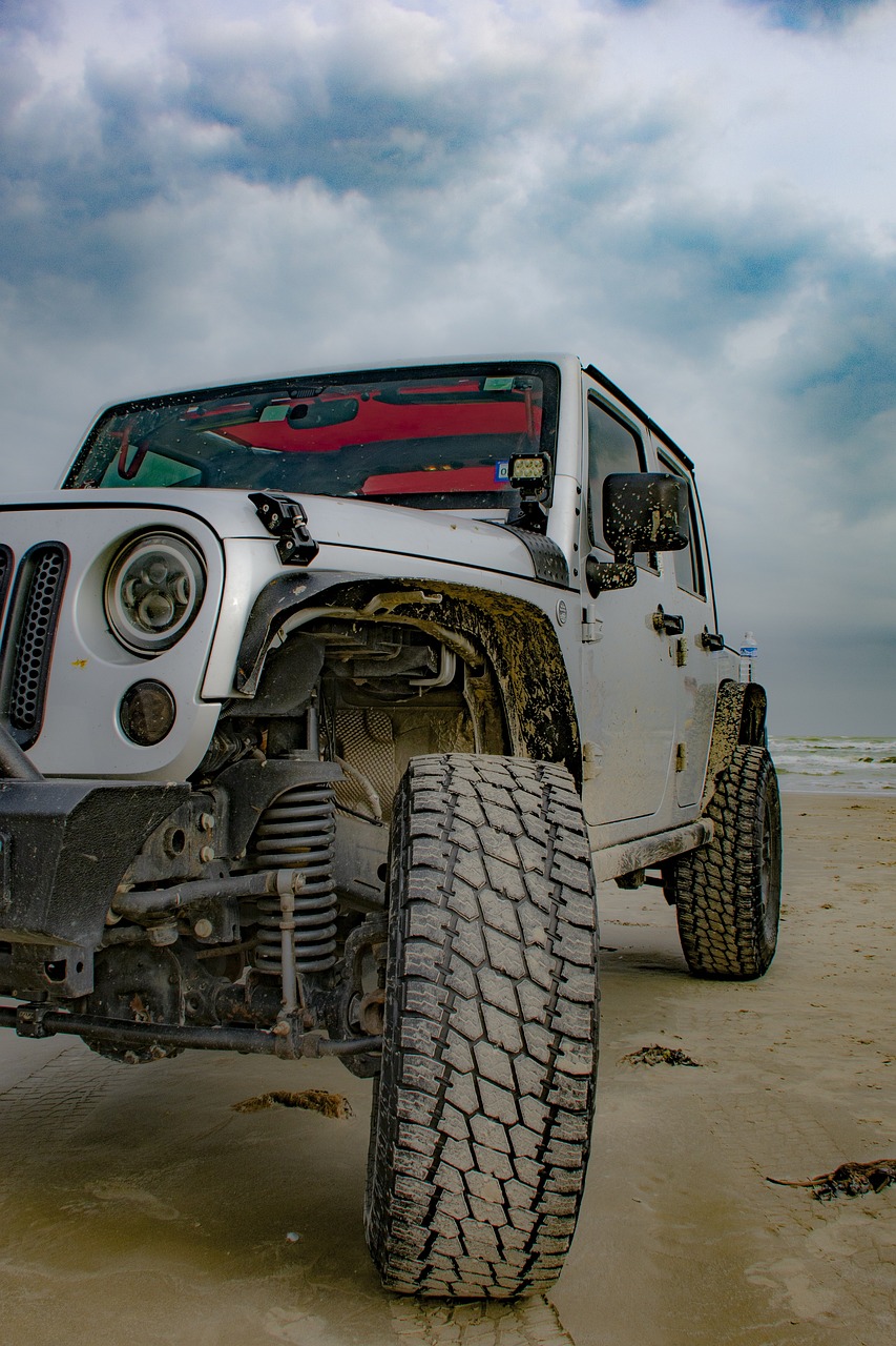 a white jeep parked on top of a sandy beach, a portrait, pixabay contest winner, renaissance, hdr detail, wet mud, dynamic low angle shot, 4k high res