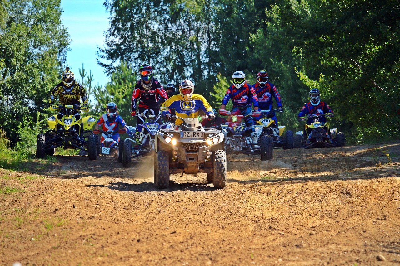 a group of people riding atvs down a dirt road, a photo, by Ivan Grohar, shutterstock, process art, battle action shot, summer season, in an arena pit, 8 0 mm photo