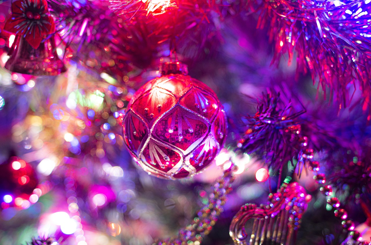 a close up of a christmas ornament on a tree, a picture, pexels, process art, bright pink purple lights, shiny colorful, high quality image”