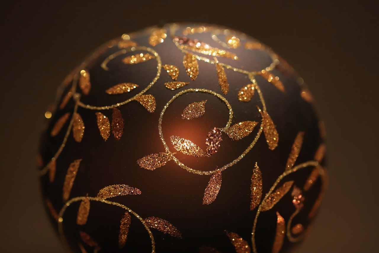 a close up of a christmas ornament on a table, a digital rendering, by Aleksander Gierymski, glowing gold embers, lacquerware, brown and gold, hd elegant