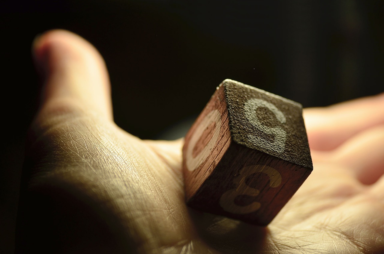 a close up of a person's hand holding a wooden dice, a macro photograph, precisionism, letter s, creative commons attribution, eight eight eight, at behance