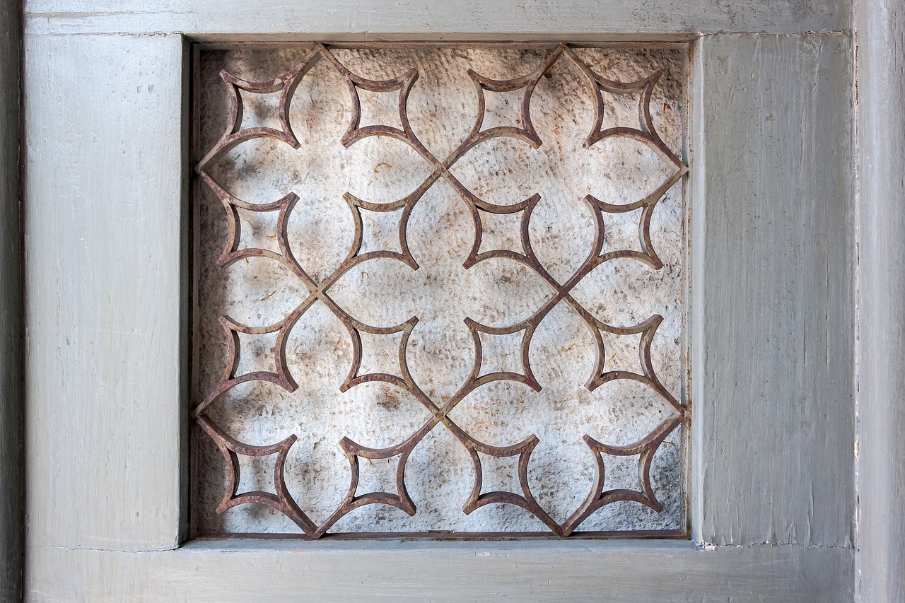 a close up of a window with a pattern on it, inspired by Gentile Bellini, wooden background, flat shaped stone relief, lorica segmentata, well worn