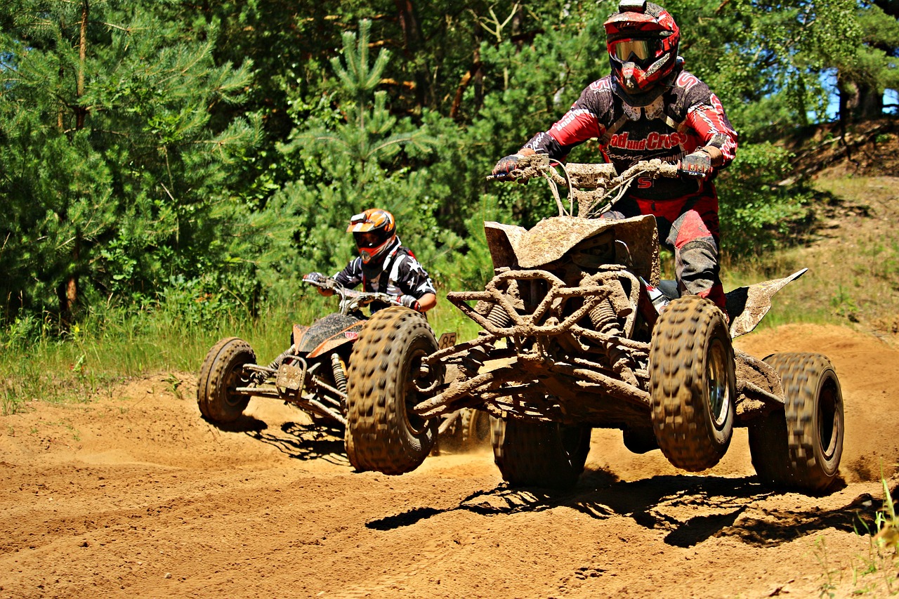a couple of people riding atvs down a dirt road, a photo, by Tom Carapic, racing, fun pose, summer season, taken with my nikon d 3