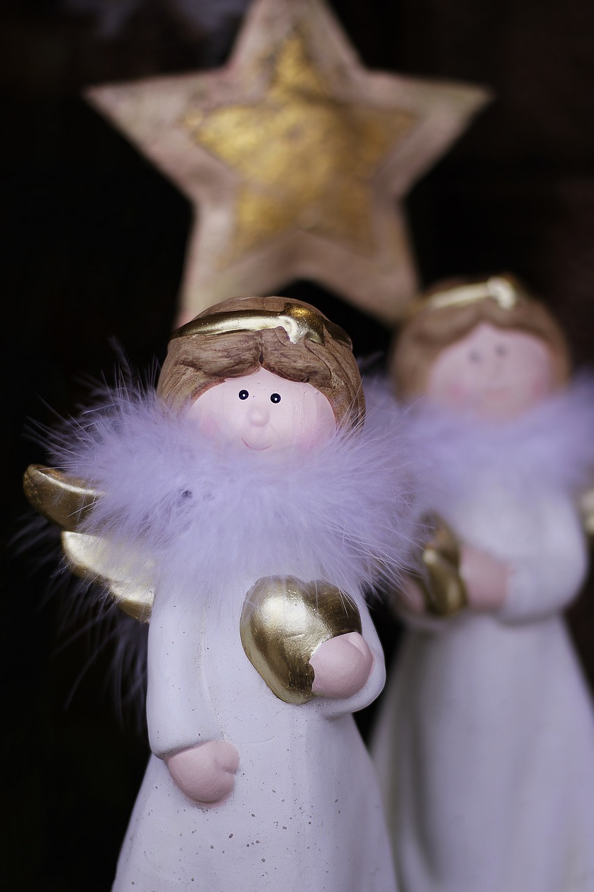 a couple of angel figurines standing next to each other, a macro photograph, blond fur, holiday season, close up shot from the top, beauttiful stars