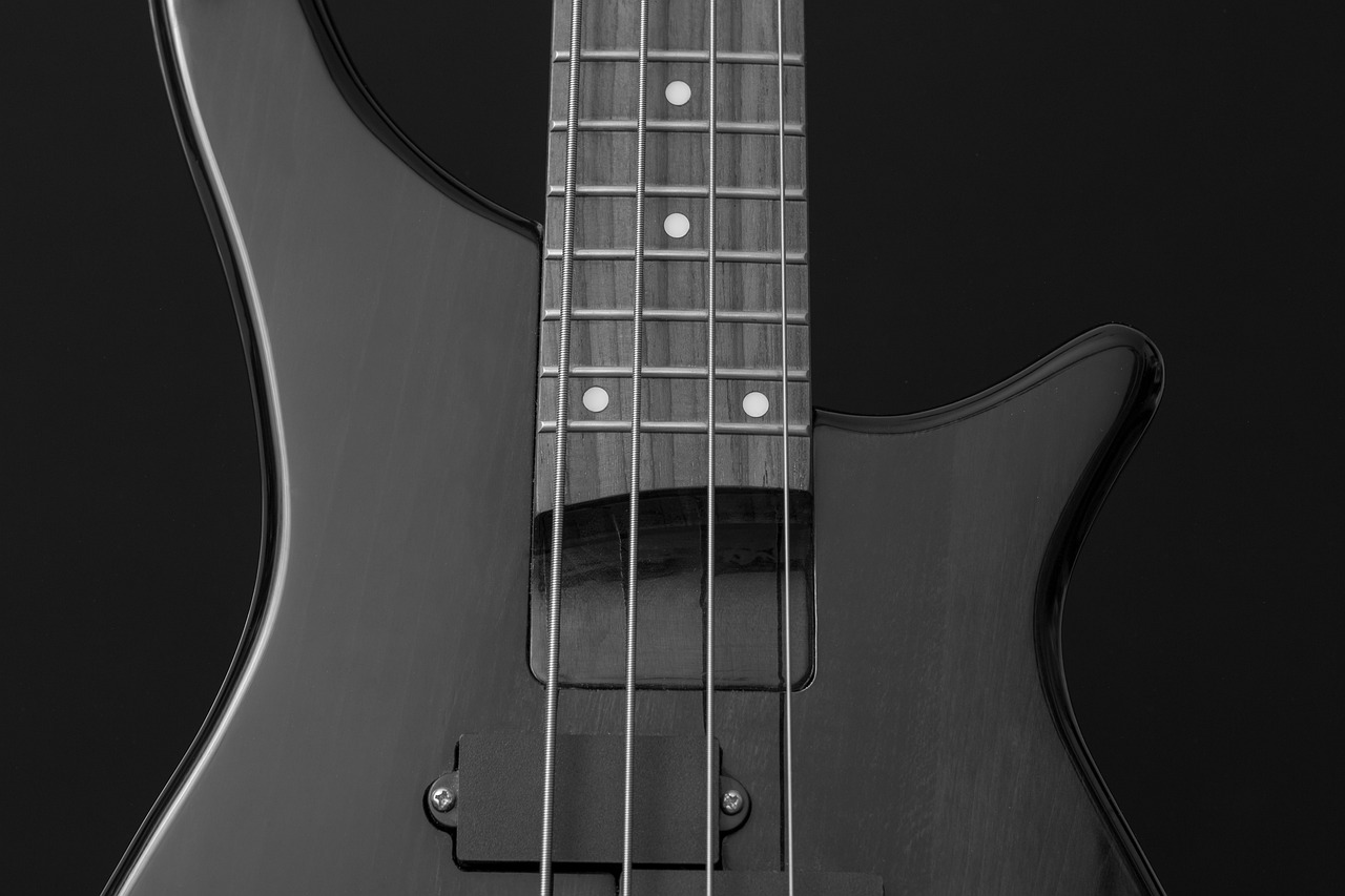 a black and white photo of a bass guitar, by Jan Kupecký, shutterstock, high detail 4k render, black color scheme, gun metal grey, modern very sharp photo