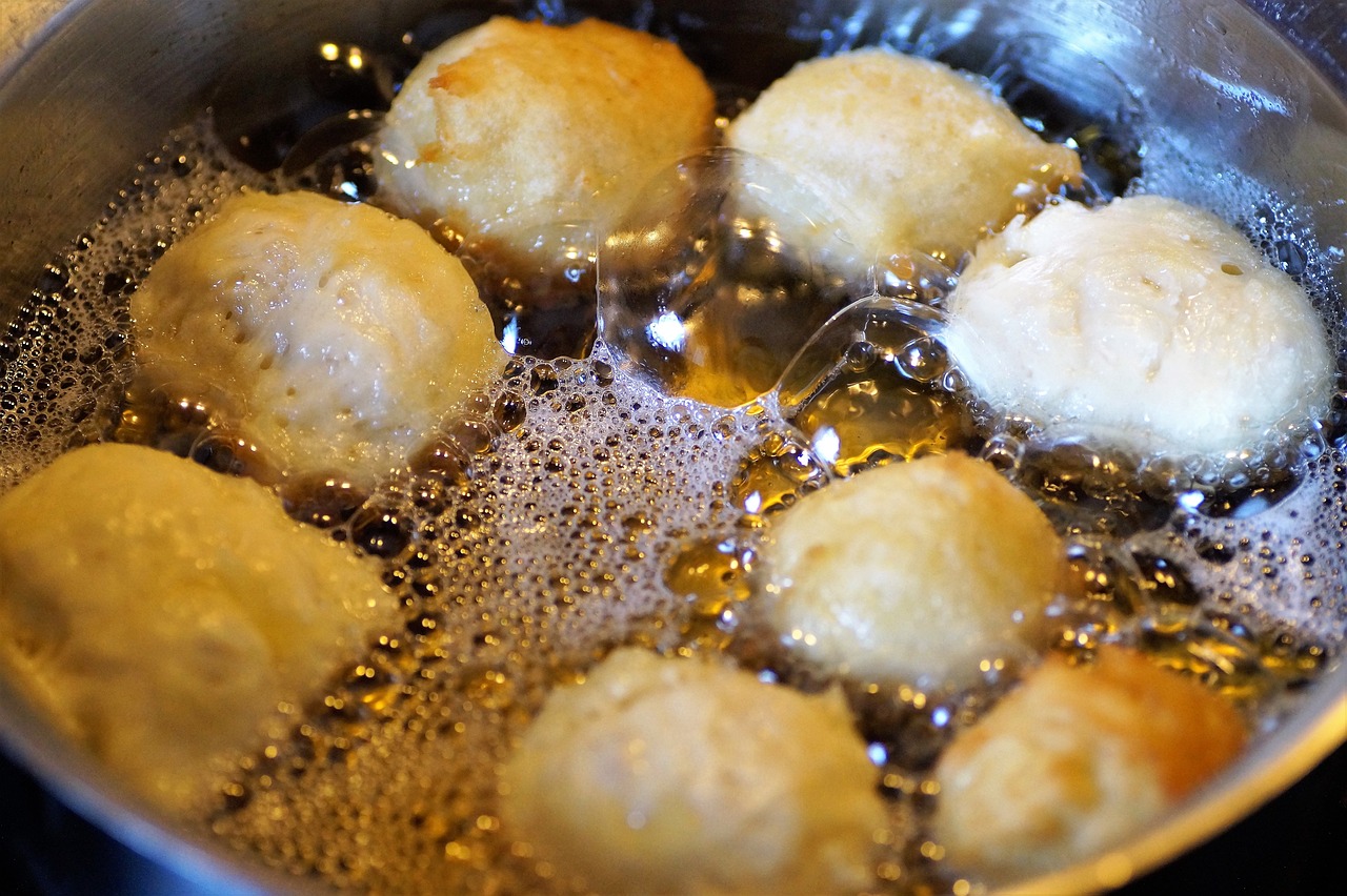 a pan filled with fried food sitting on top of a stove, pixabay, process art, puffballs, floating chinese lampoons, butter, upclose