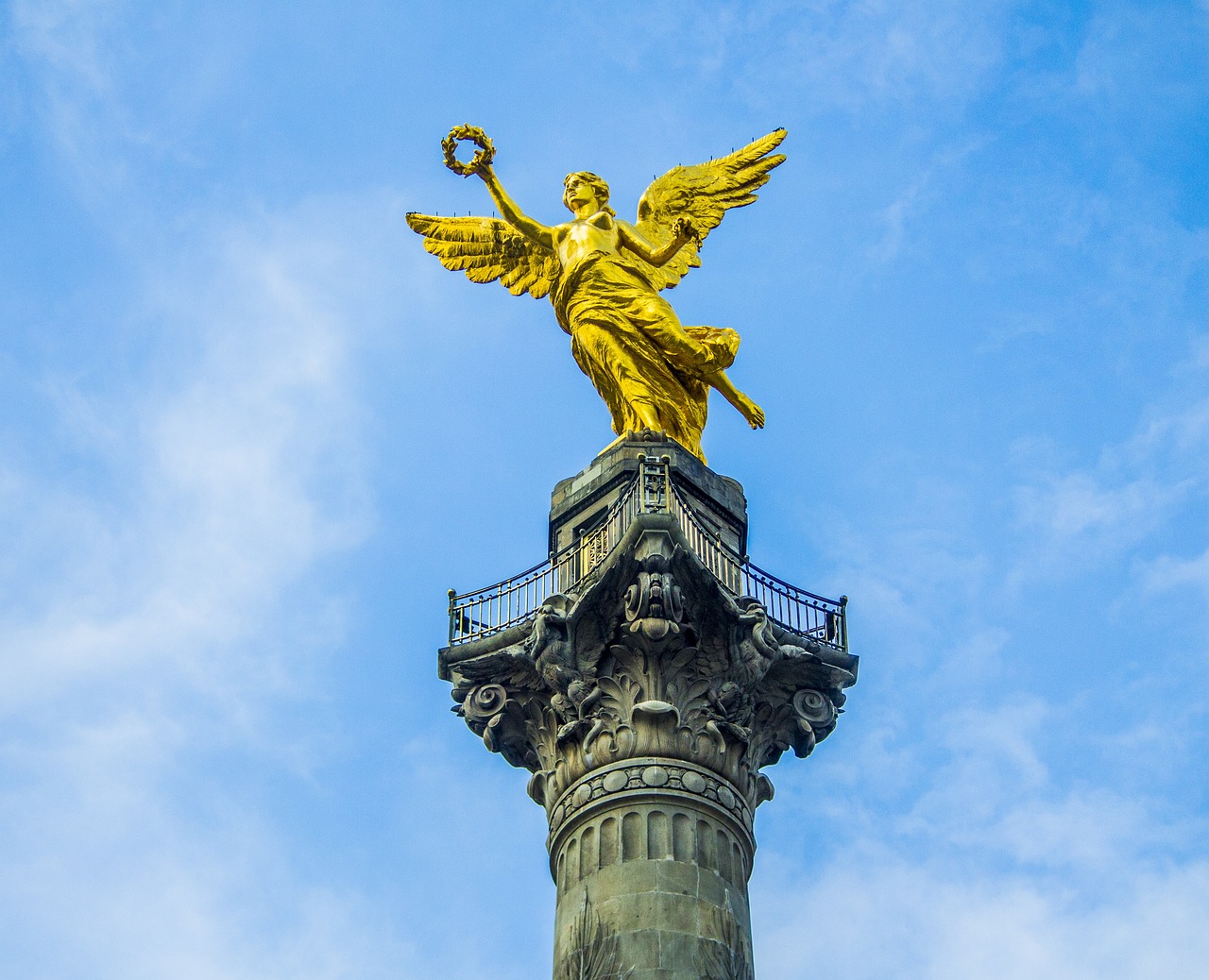 a statue of an angel on top of a column, a statue, mexico city, golden halo, berlin, image
