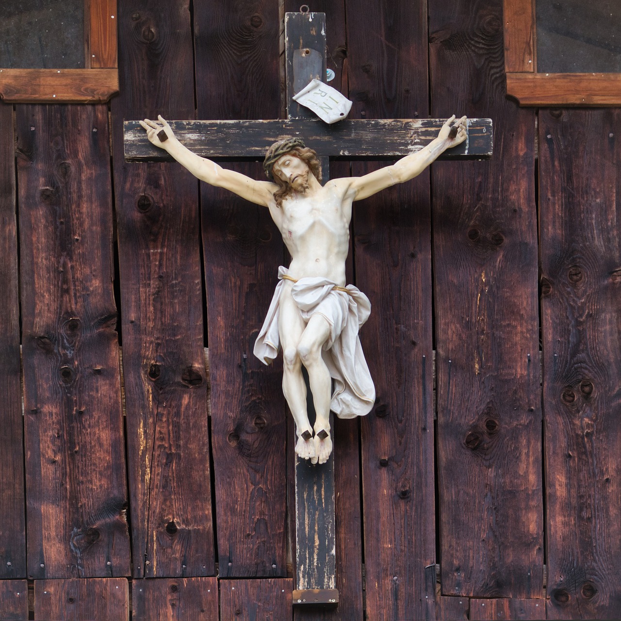a statue of jesus on a wooden cross, a picture, by Erwin Bowien, shutterstock, hung above the door, colorado, rustic, very very well detailed image