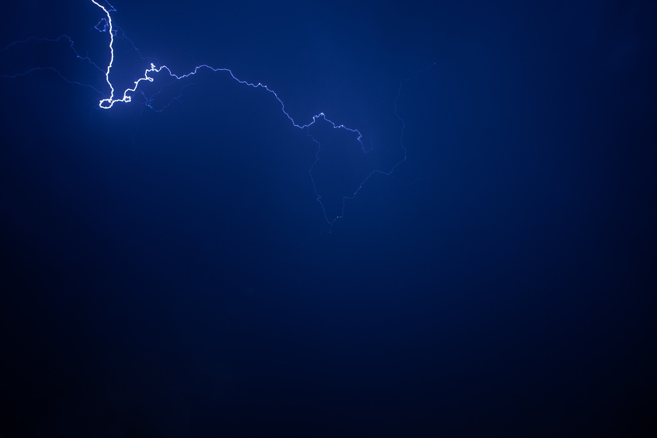 a couple of lightnings that are in the sky, minimalism, dark blue, flash photo