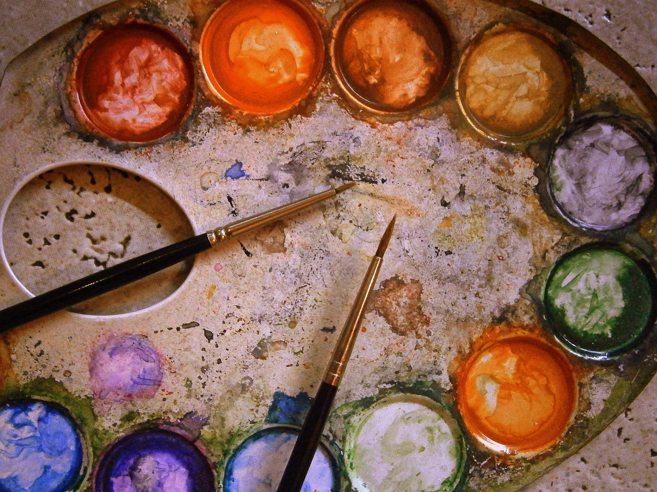 a close up of a paint palette with a paint brush, a watercolor painting, by Marie Bashkirtseff, flickr, circles, old paints, orange palette, elaborate composition