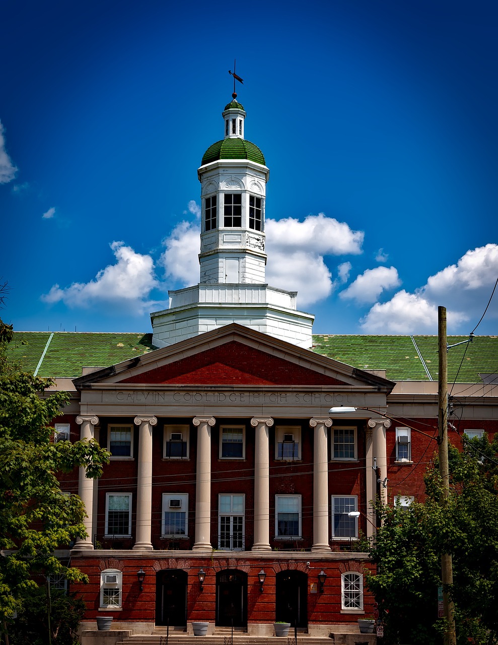 a building with a clock tower on top of it, a portrait, by Tom Carapic, flickr, brandywine school, shot on nikon z9, summer day, many columns