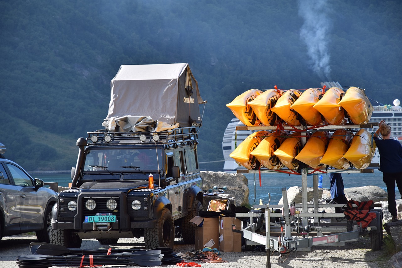 a truck with a bunch of life rafts on top of it, a picture, by Dietmar Damerau, fjords, on set, lotus, rambo