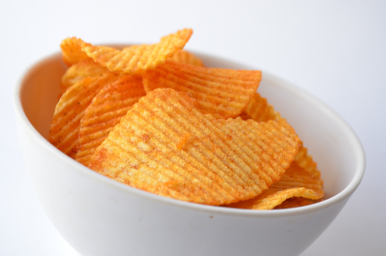 a bowl filled with potato chips on top of a table, inspired by Chippy, close-up product photo