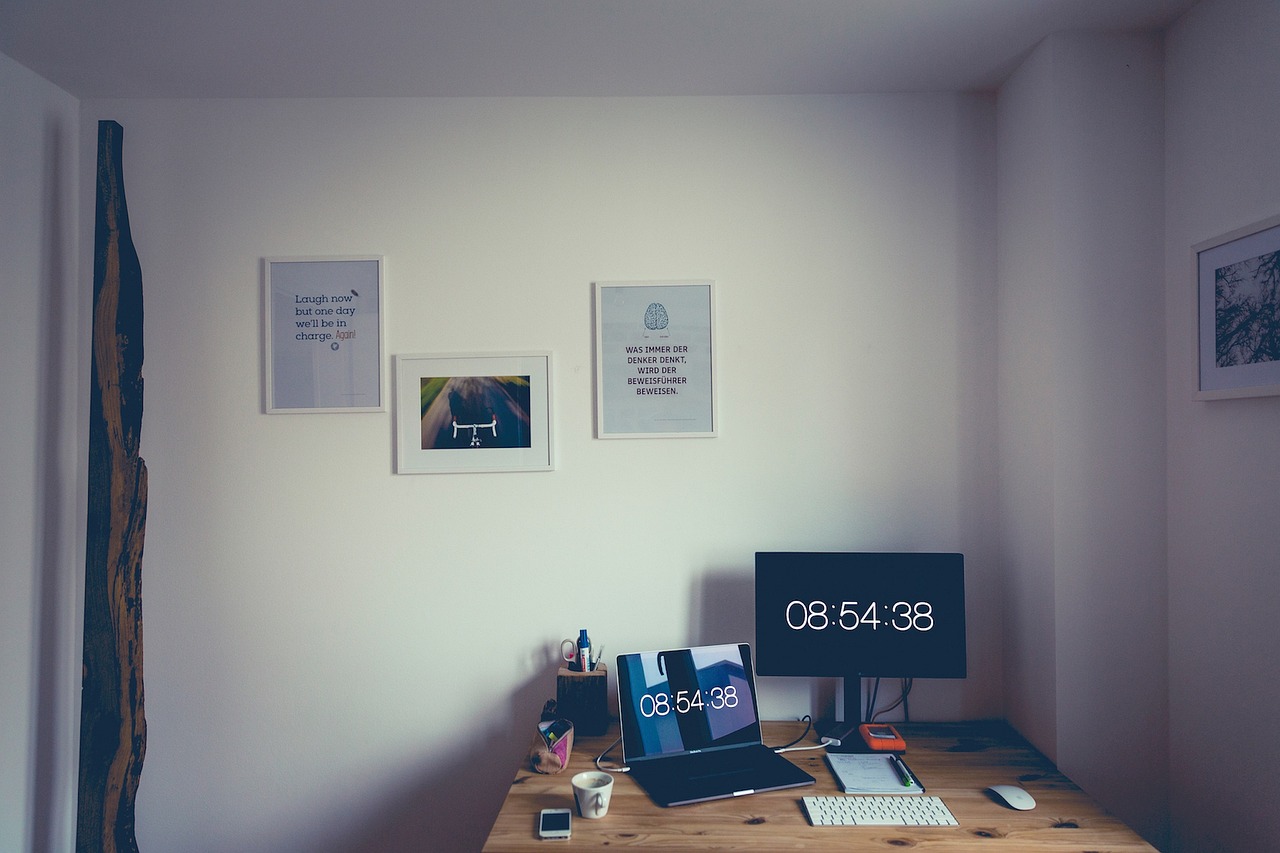 a desktop computer sitting on top of a wooden desk, a minimalist painting, by Romain brook, postminimalism, clocks, square pictureframes, there were posters on the wall, motivational