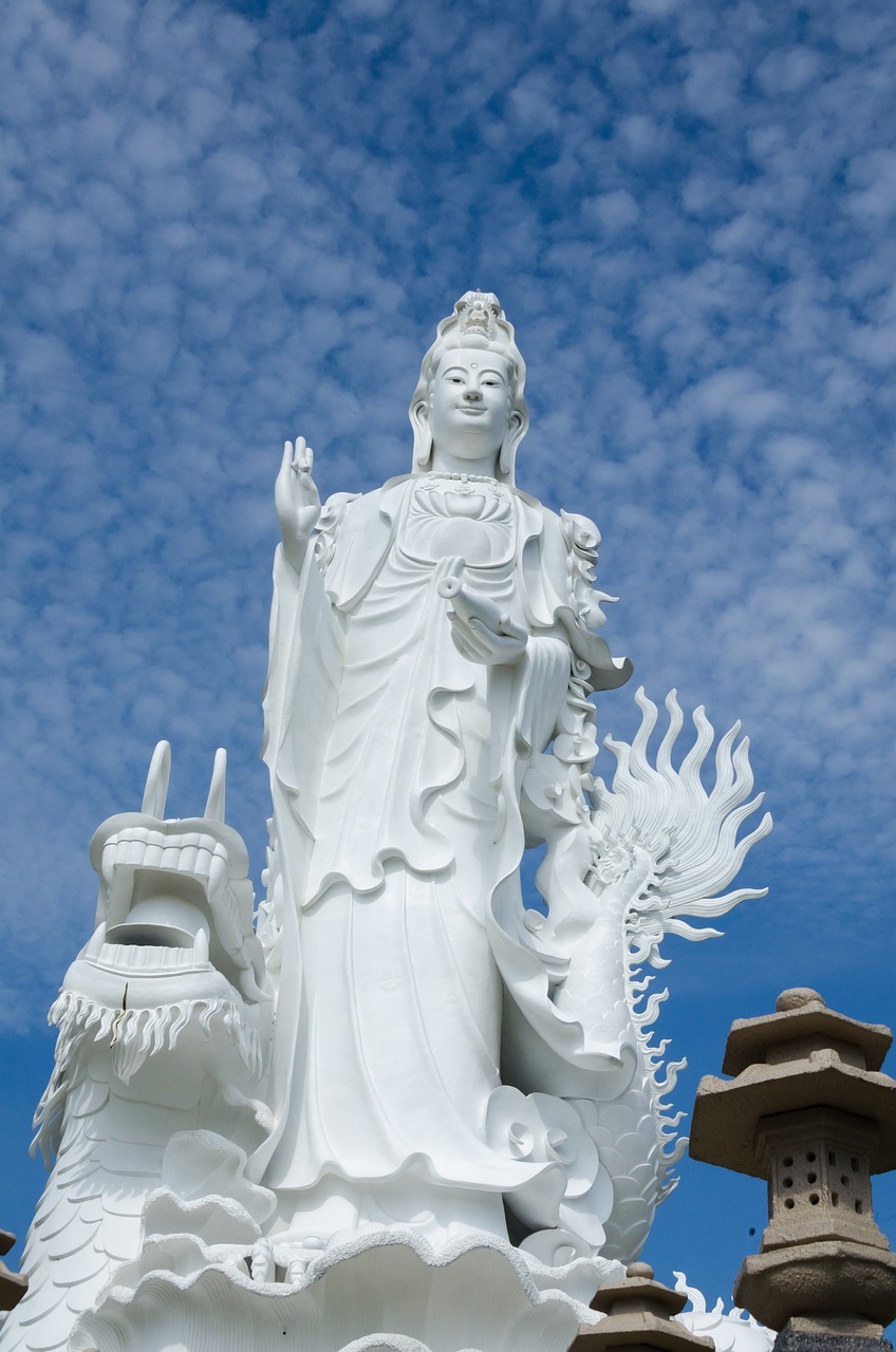 a statue of a woman holding a dragon, a statue, inspired by Pu Hua, guanyin, wearing white cloths, upward shot, thai temple