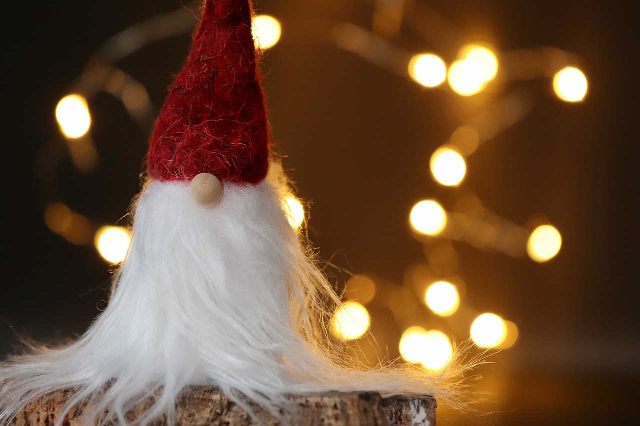 a gnome sitting on top of a piece of wood, pexels, string lights, very long white beard and hair, red hat, wallpaper - 1 0 2 4
