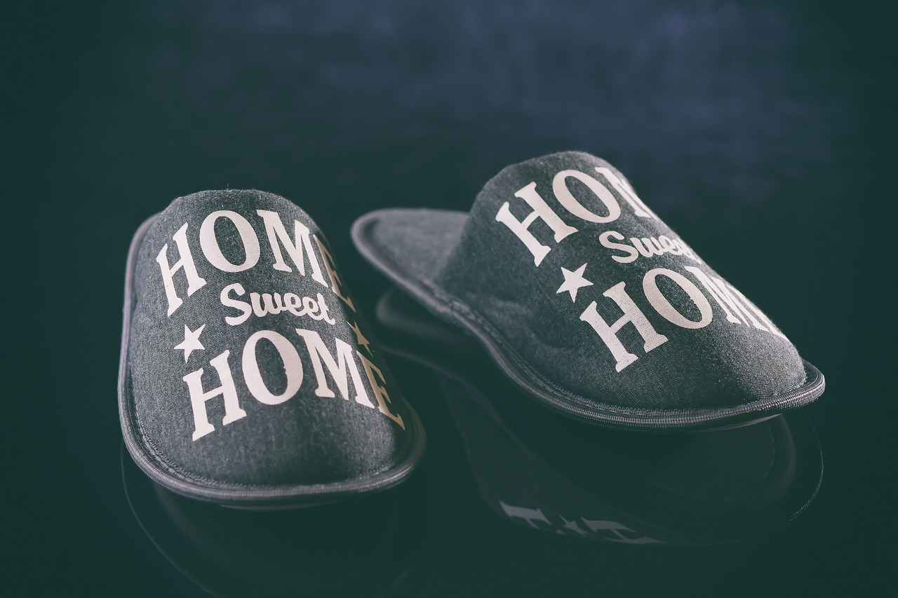 a pair of slippers that say home sweet home, by Matija Jama, shutterstock, shot on sony a 7 iii, low key, morning. hyperrealism, home video