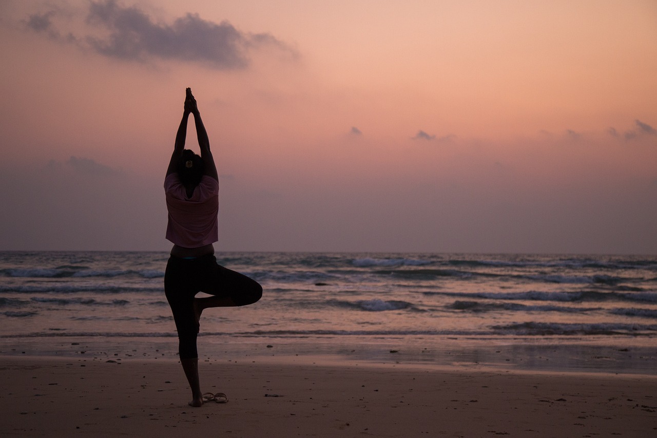 a woman doing yoga on the beach at sunset, pixabay, standing on two legs, wikimedia, sri lanka, medium detail