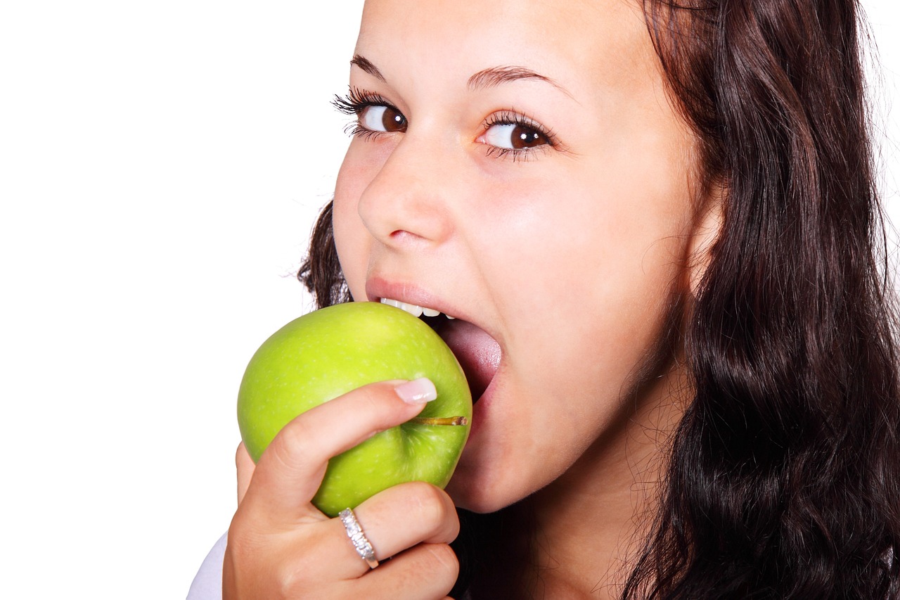 a woman biting into an apple with her mouth, by John Luke, shutterstock, a green, ladies, a super-smart, square