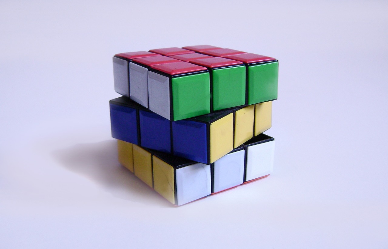 three rubik cubes stacked on top of each other, inspired by Ernő Rubik, flickr, cubo-futurism, view from the side”, colour, glossy surface, taken with a pentax k1000