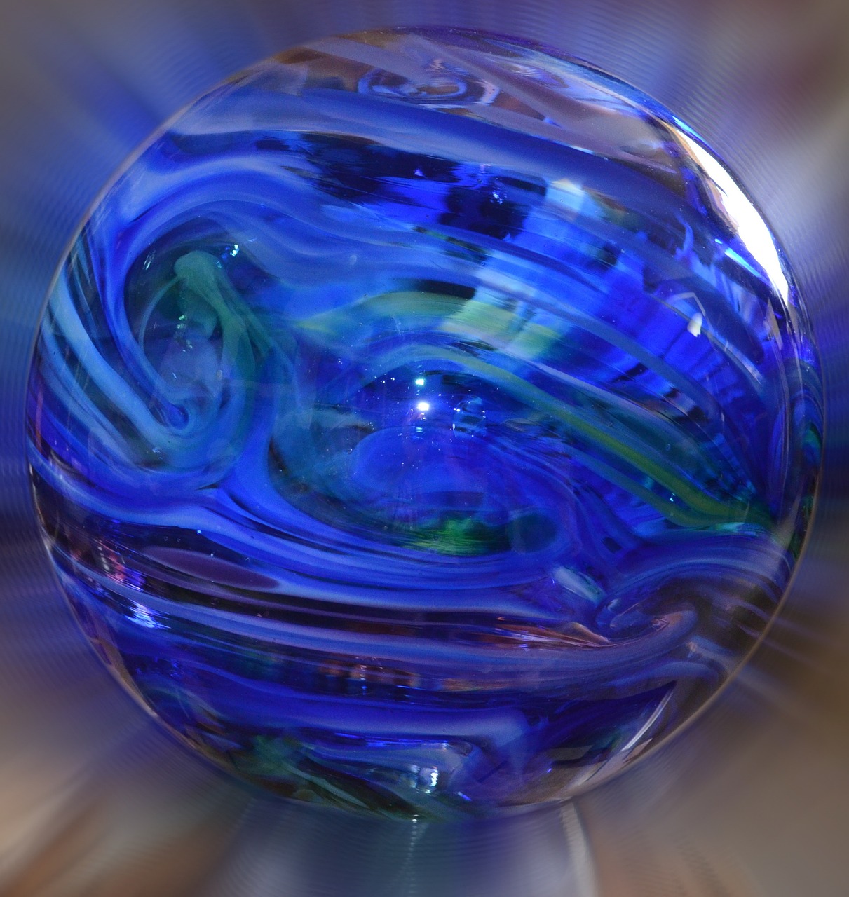a close up of a glass ball on a table, digital art, by Arnie Swekel, flickr, digital art, lapis lazuli, spinning whirlwind, iridescent venetian blown glass, 1 / 4 portrait