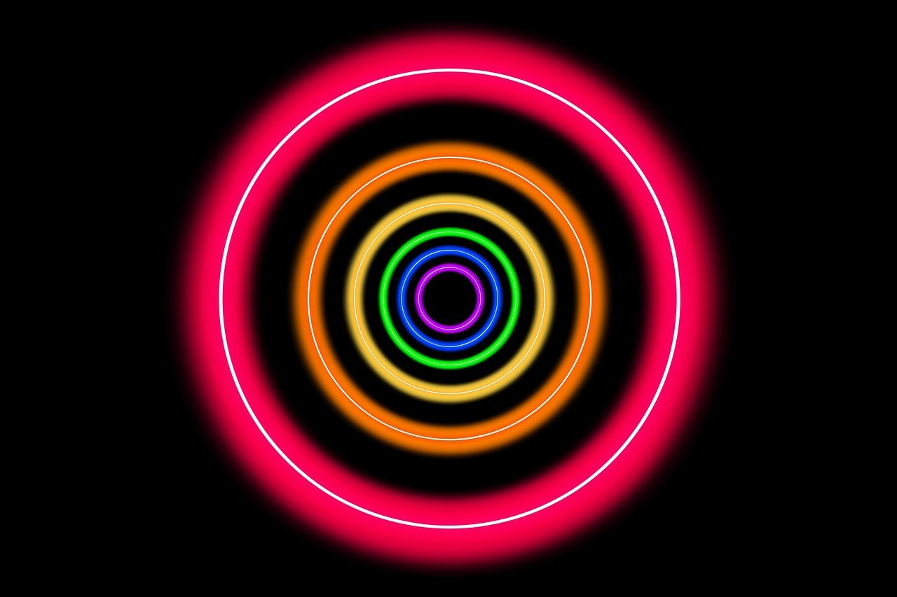 a close up of a neon ring on a black background, a digital rendering, flickr, computer art, concentric circles, high res, multicolored vector art, pink and orange neon lights