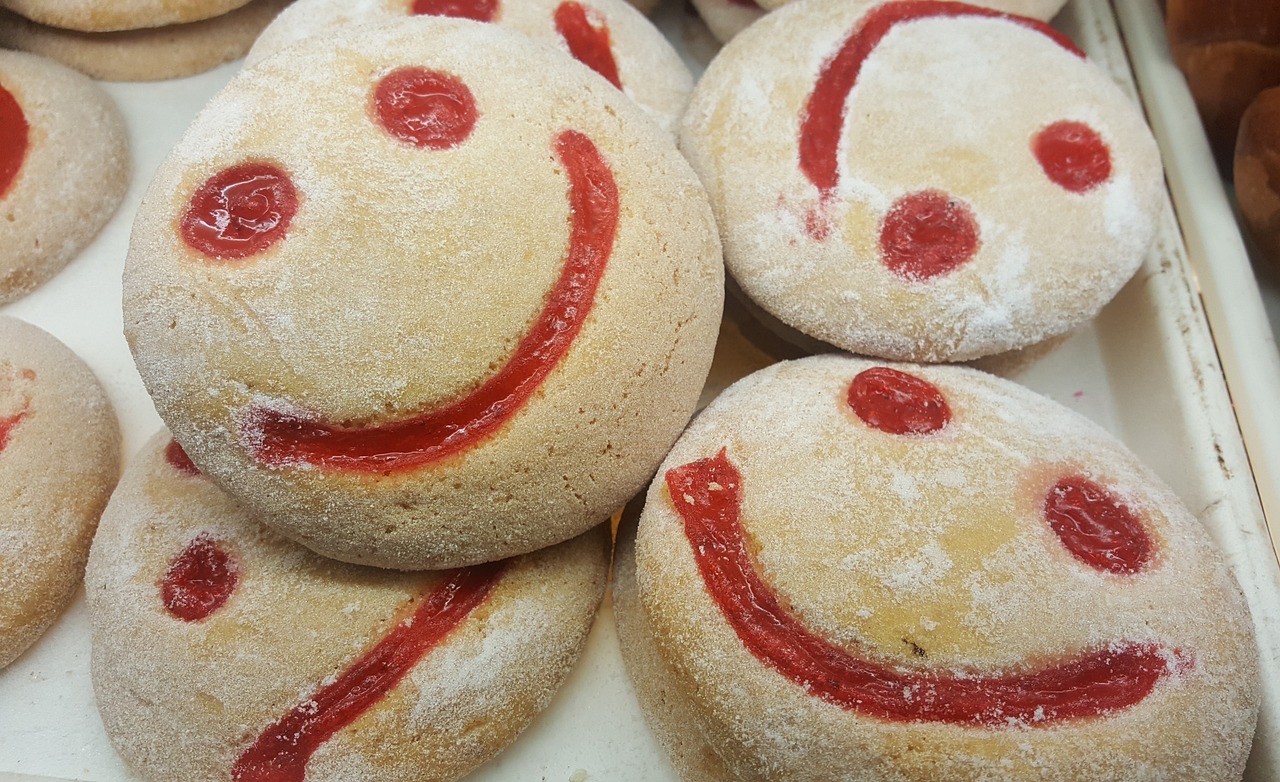 a bunch of doughnuts with a smiley face drawn on them, mingei, reds, covered in white flour, therookies, local close up