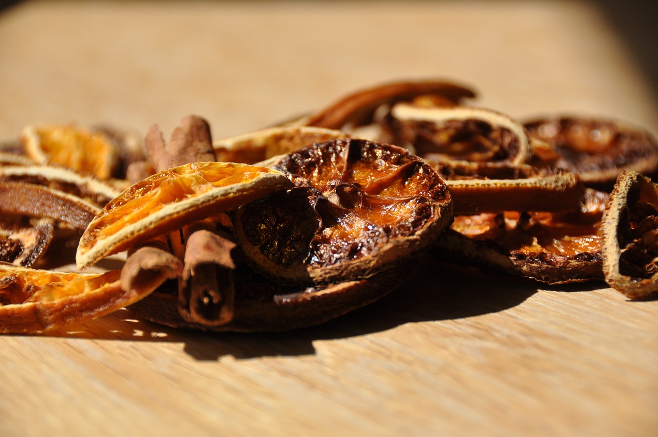 a pile of dried fruit sitting on top of a wooden table, a macro photograph, cinnamon, close-up product photo