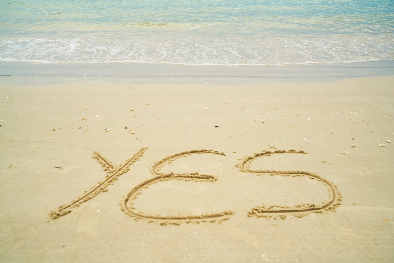 the word yes written in the sand on the beach, a picture, ideas