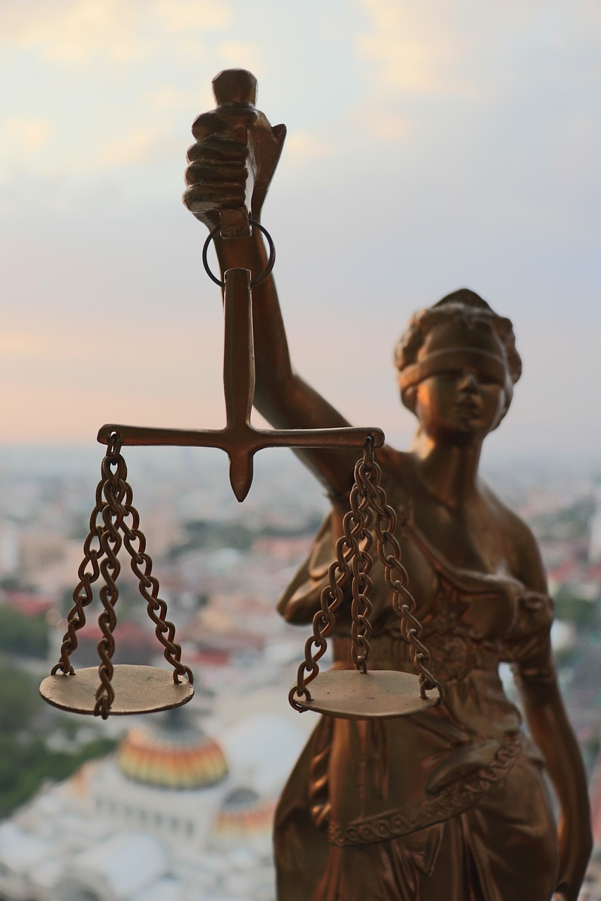 a statue of lady justice holding a scale, a statue, taken at golden hour, birdseye view, looking across the shoulder, suspended in air