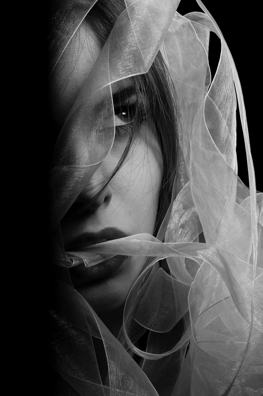 a black and white photo of a woman wearing a veil, inspired by irakli nadar, art photography, beautiful art uhd 4 k, andrey gordeev, black and white background, transparent glass woman