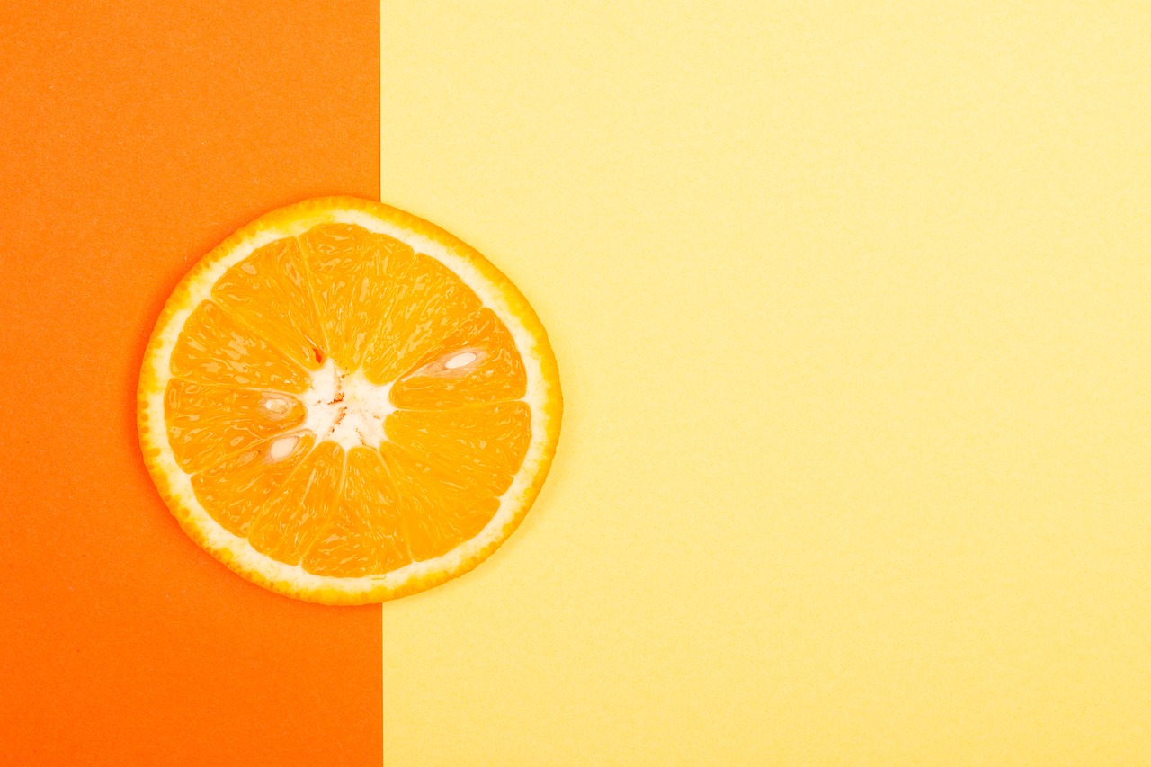 a half of an orange sitting on top of a table, postminimalism, summer color pattern, high quality product image”