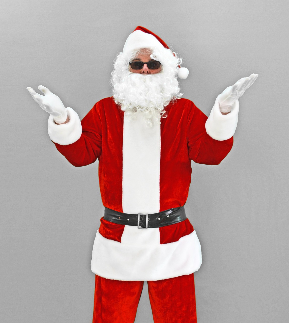 a man dressed as santa claus poses for a picture, a photo, istockphoto, neoprene, 3/4 front view, hands