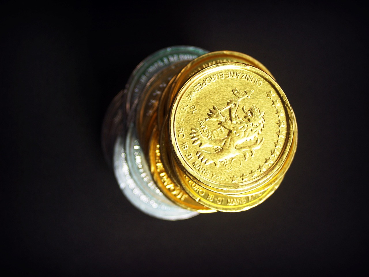 a bunch of coins sitting on top of each other, a macro photograph, gold silver, miniature product photo