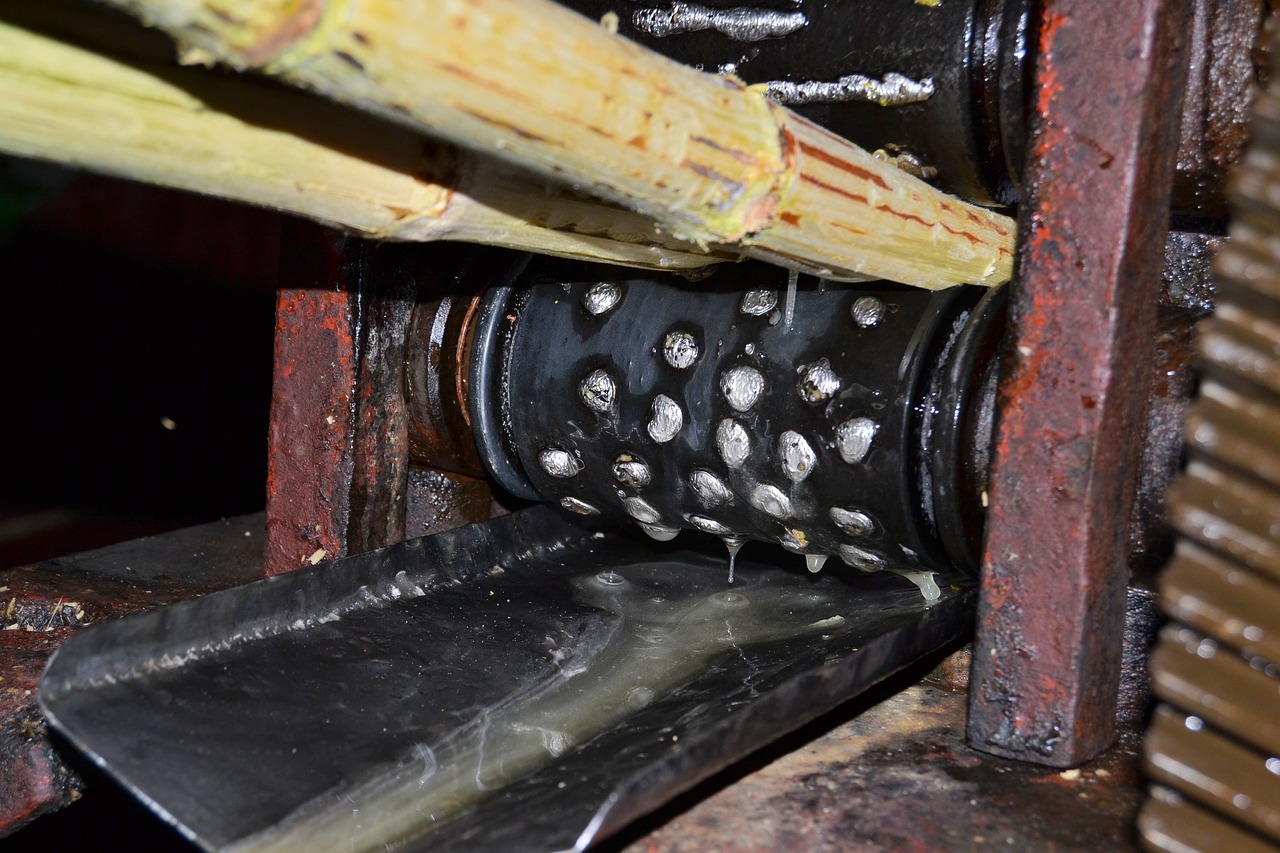 a knife sitting on top of a piece of metal, flickr, mingei, water wheel, inside view, bamboo, covered with liquid tar. dslr