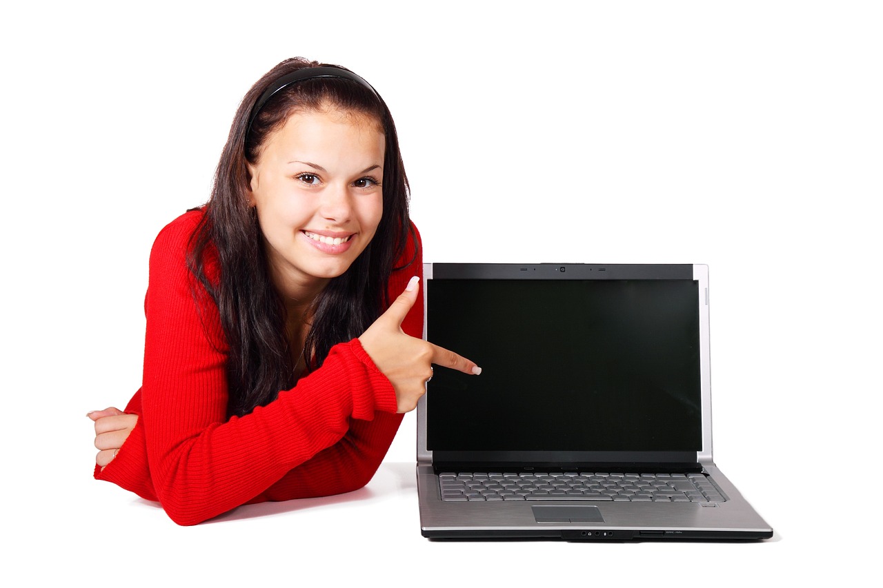 a woman holding a credit card in front of a laptop, a photo, with pointing finger, teen girl, istockphoto, award winning webdesign