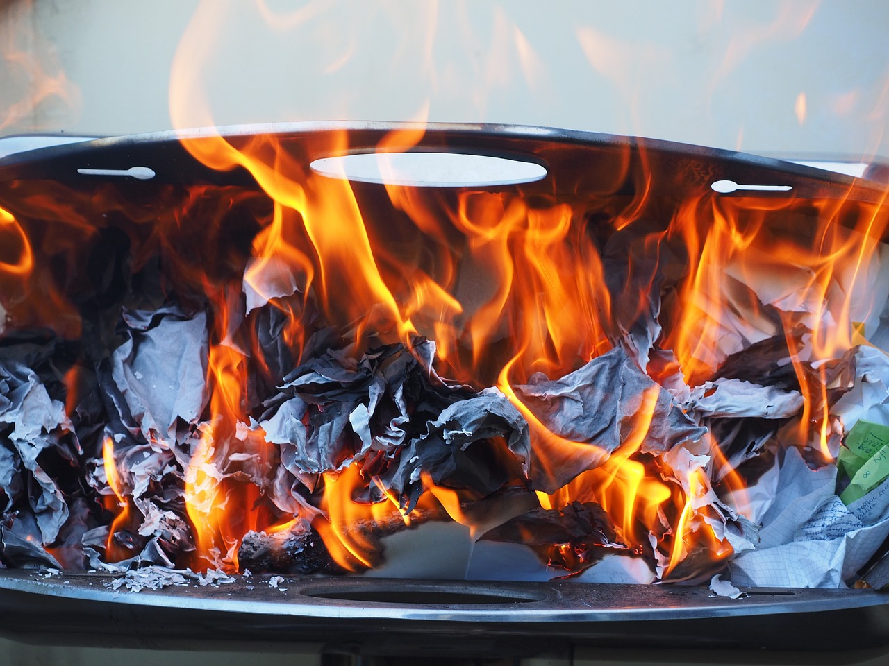 a close up of a grill with flames coming out of it, a picture, by Rodney Joseph Burn, shutterstock, fine art, burnt paper, molten plastic, on display, awkward situation