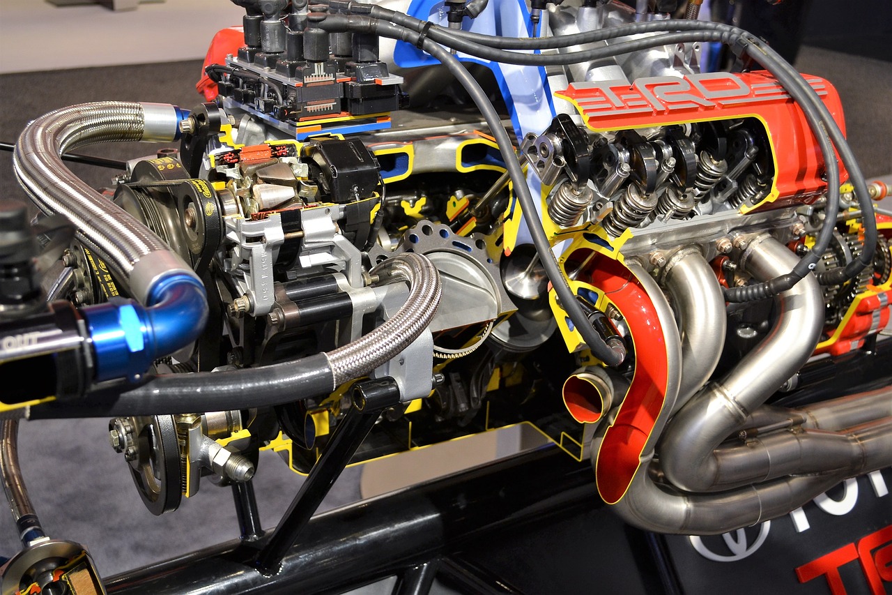 a close up of a car engine on display, a picture, by Richard Carline, shutterstock, with elements of the f40, oil lines, cut-away, turbo