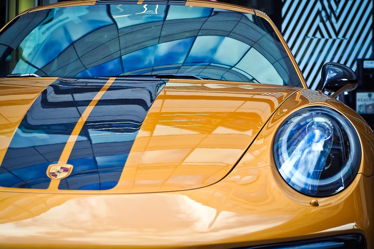 a yellow sports car parked in front of a building, a picture, unsplash, hyperrealism, glass visor, blue and gold, macro up view metallic, porche
