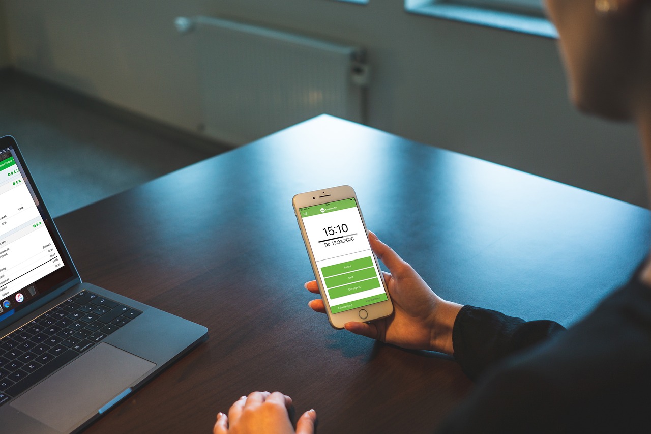 a person sitting at a table with a laptop and a cell phone, green colored theme, mobile learning app prototype, sitting in a waiting room, productphoto