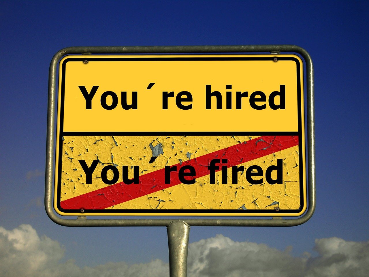a yellow sign that says you're hired you're fired, a photo, by Allen Jones, renaissance, manipulation, firey, lightbox, billboard image