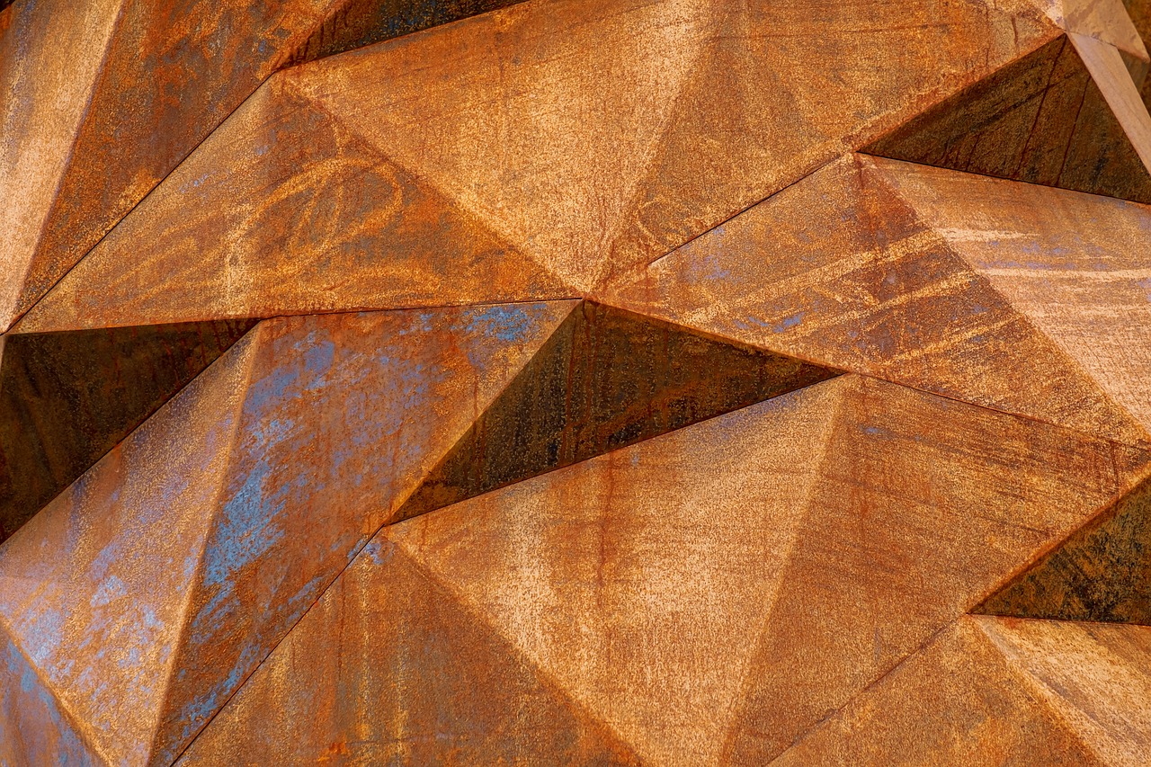 a close up of a piece of metal, inspired by Christo, trending on pixabay, geometric abstract art, rich vibrant detailed textures, polygonal wooden walls, rusty metal towers, engraved texture