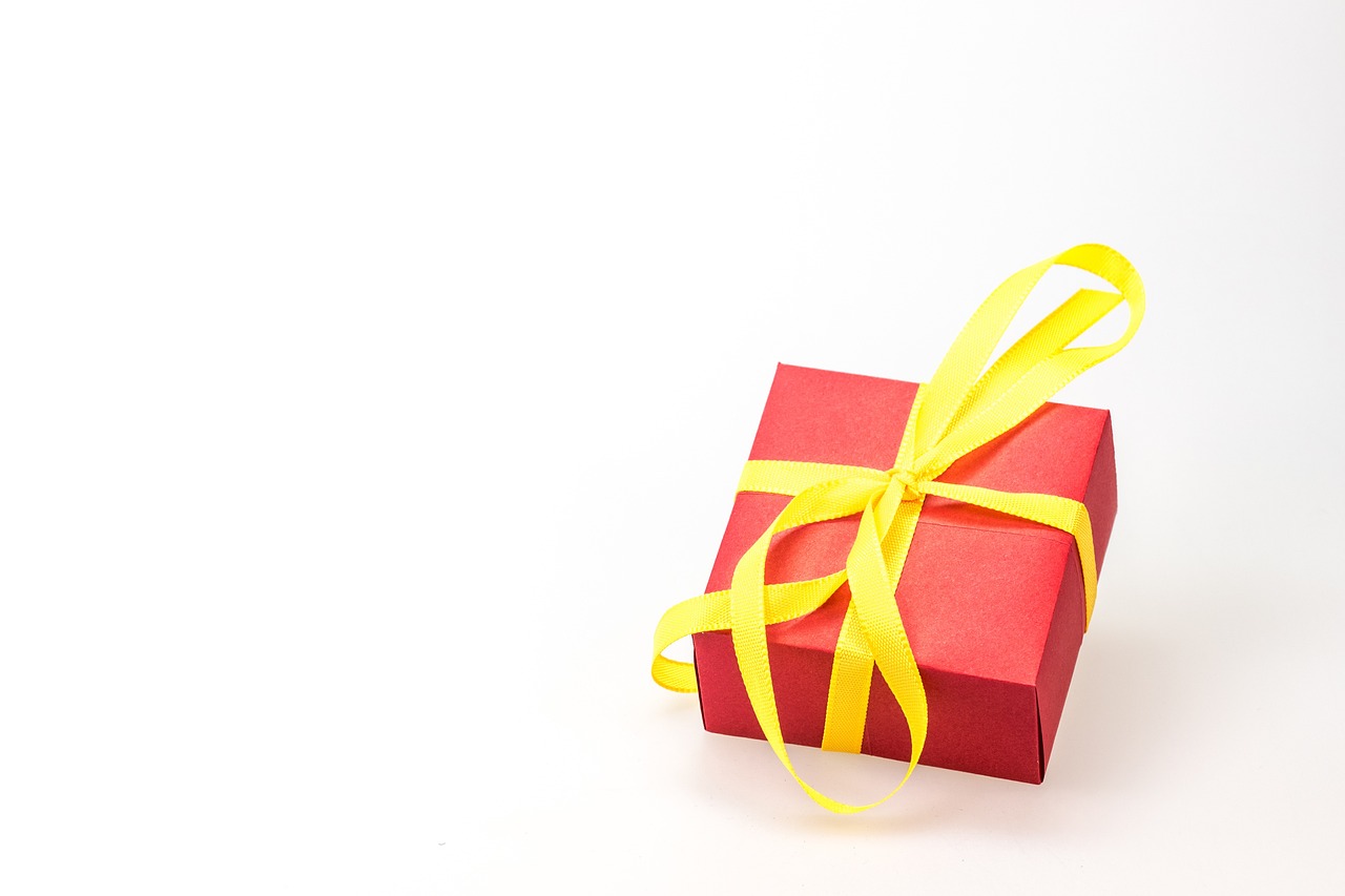 a red gift box with a yellow ribbon, a stock photo, pixabay, minimalism, with a white background, 4 k photo, dad, blog-photo