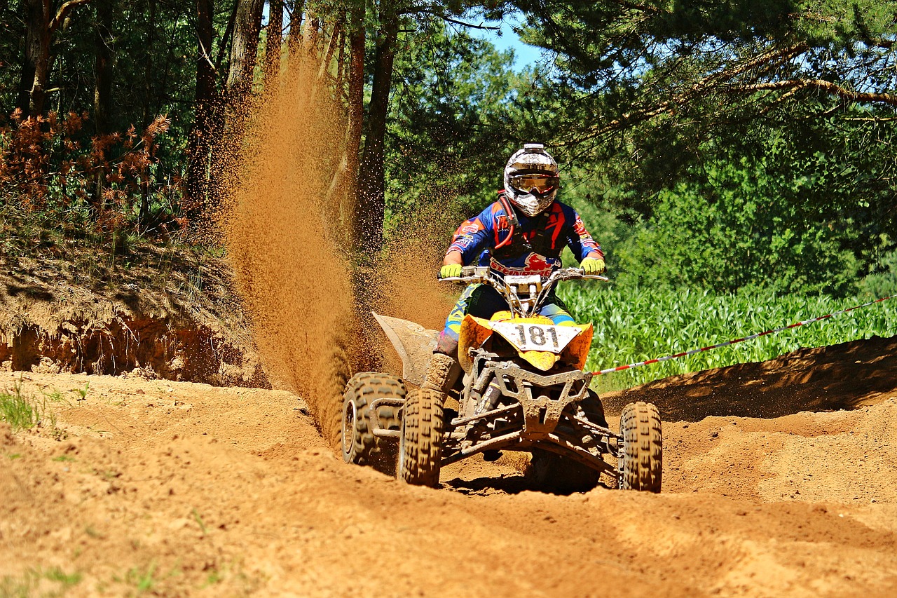 a man riding on the back of a dirt bike, a photo, by Tom Carapic, shutterstock, all terrain vehicle race, underbrush wash, at racer track, iphone photo