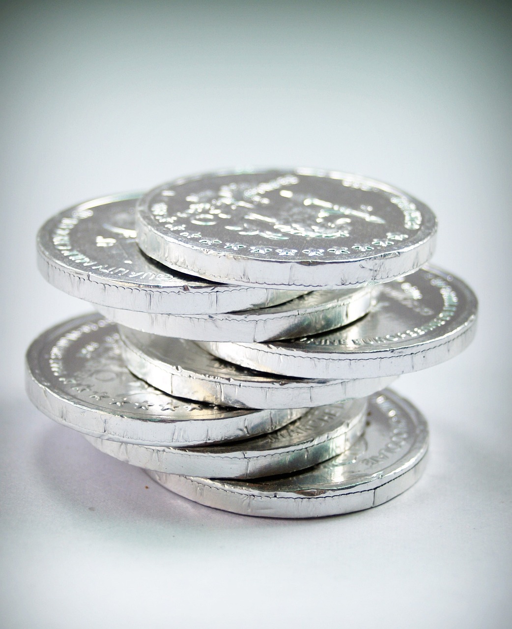 a stack of silver coins sitting on top of each other, inspired by Georg Friedrich Schmidt, flickr, dau-al-set, chocolate, 5 5 mm photo, israel, sugar