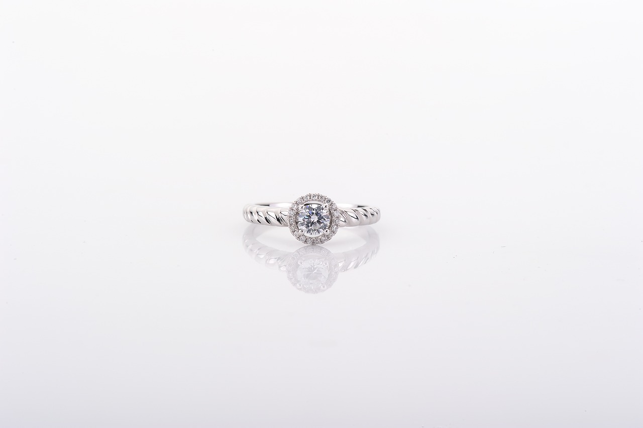 a diamond ring sitting on top of a white surface, a stipple, by Tadashi Nakayama, trending on cg society, product introduction photo