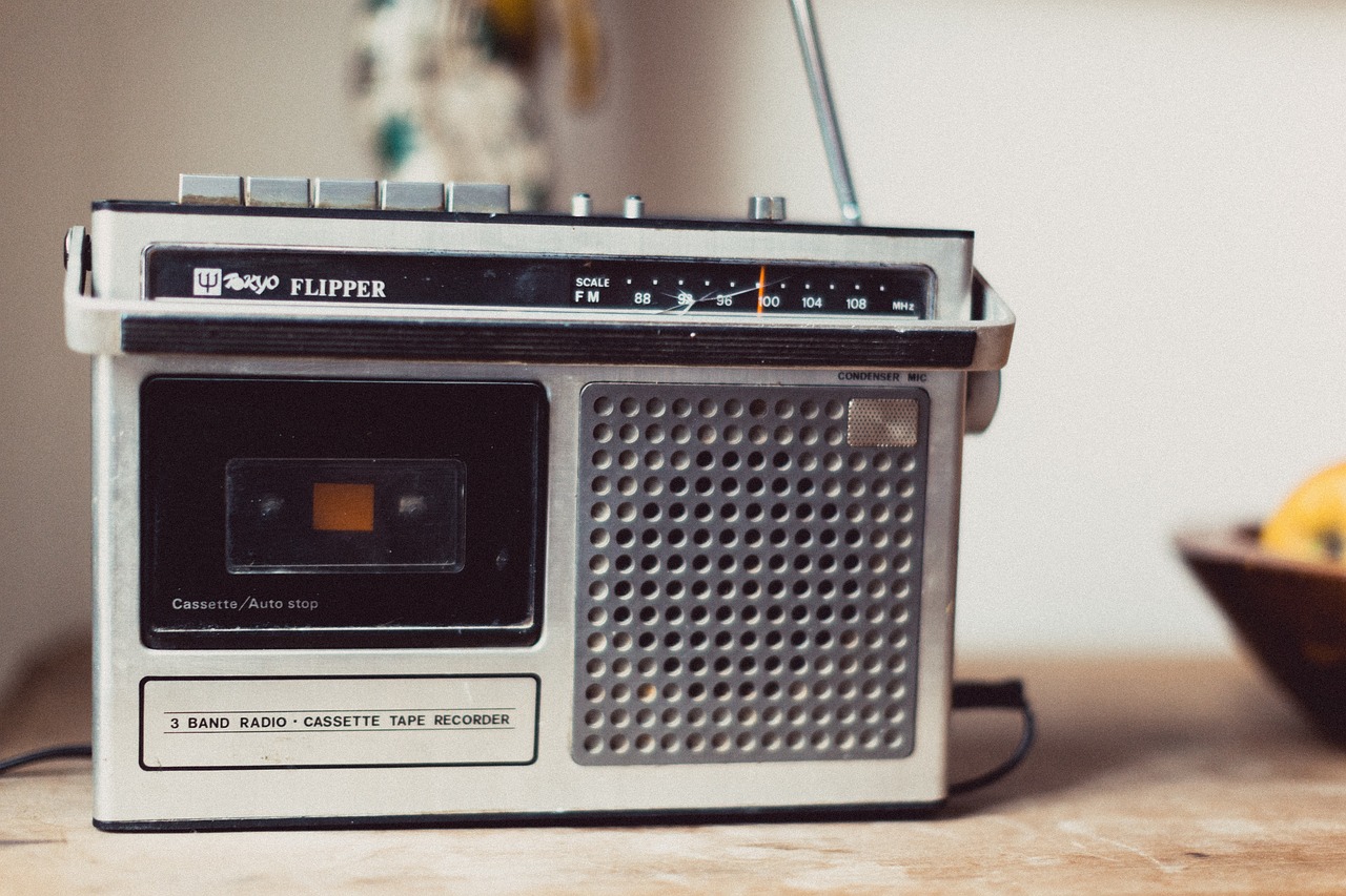 a radio sitting on top of a table next to a bowl of fruit, unsplash, old tape, banner, candid portrait photo, rippling