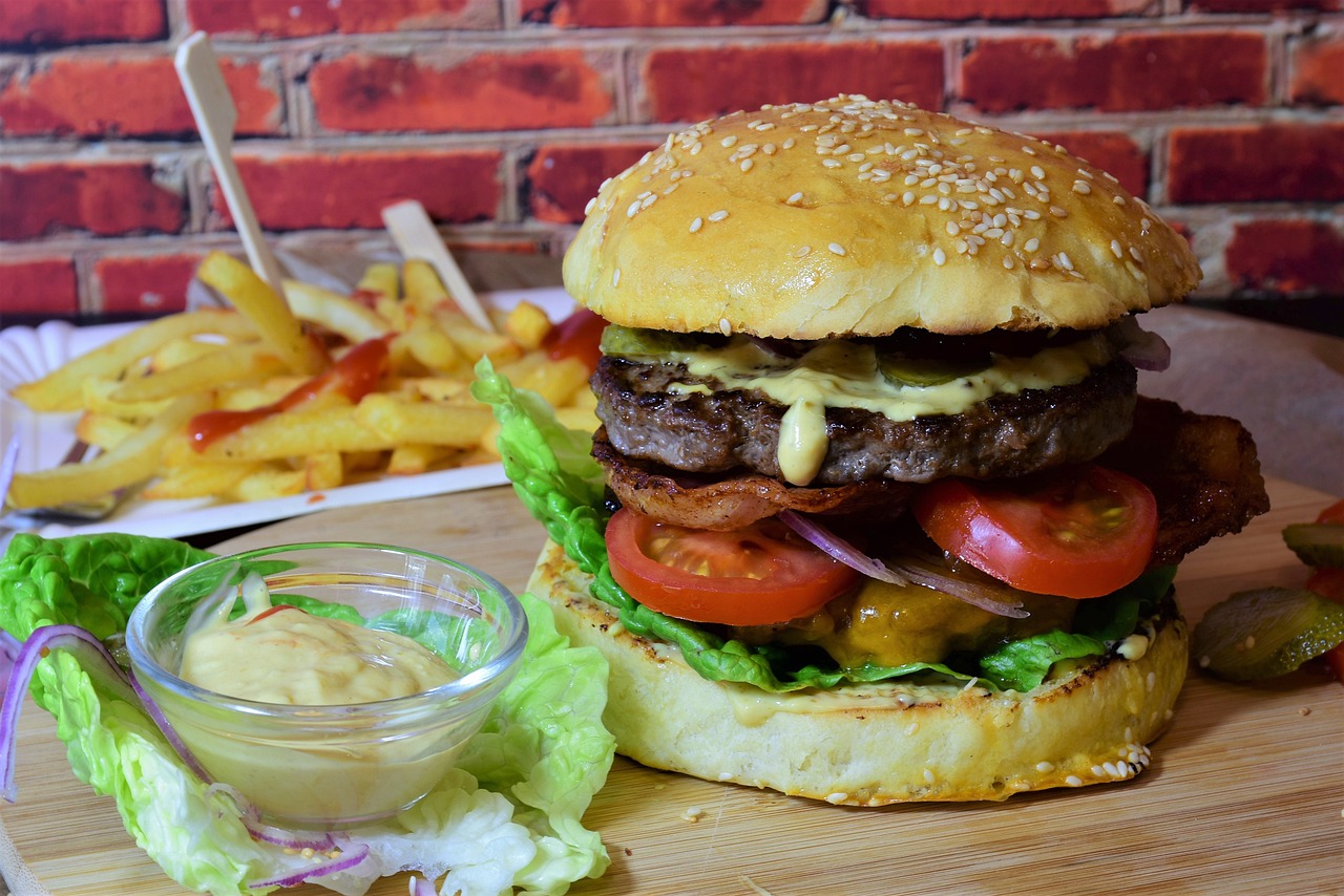 a hamburger sitting on top of a cutting board next to fries, a portrait, pexels, figuration libre, stacked image, foodphoto, very large bosum, !!highly detailed